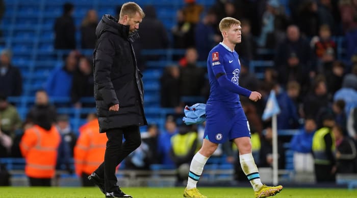 Graham Potter walking off the field after a Chelsea loss.